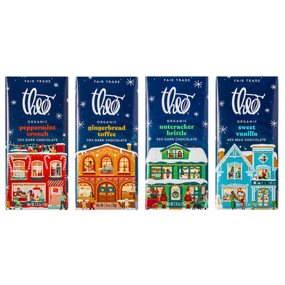 Four Theo Organic chocolate bars with festive village designs on the packaging.
